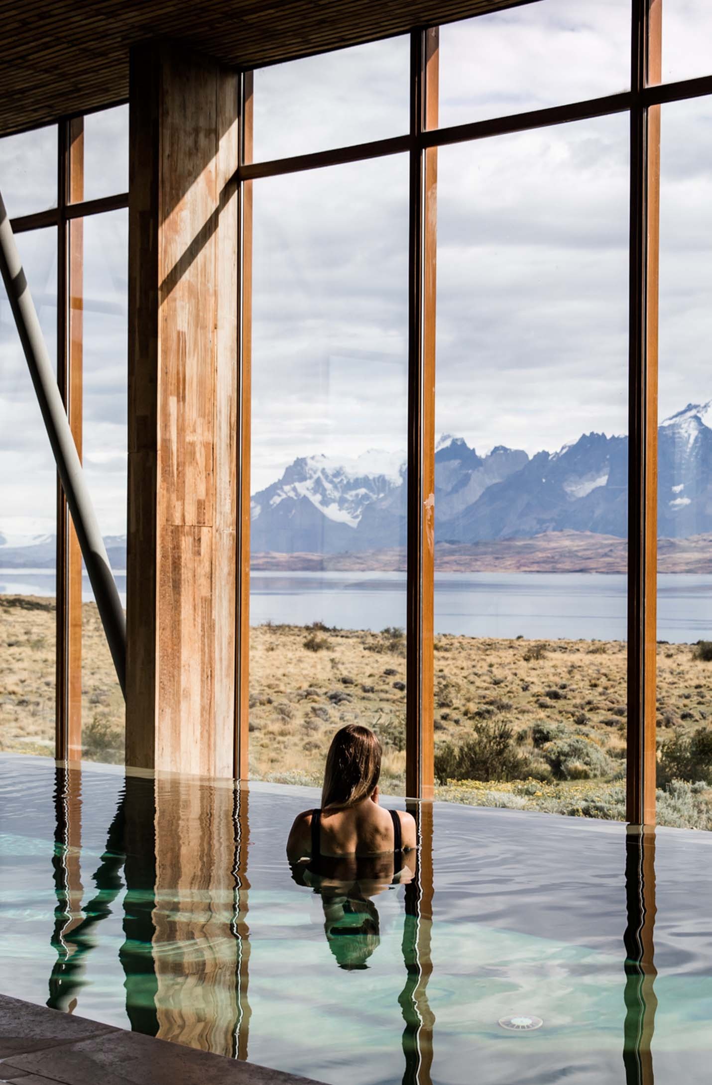 Indoor pool with floor-to-ceiling landscape views at Tierra Patagonia, Torres del Paine, Chile
