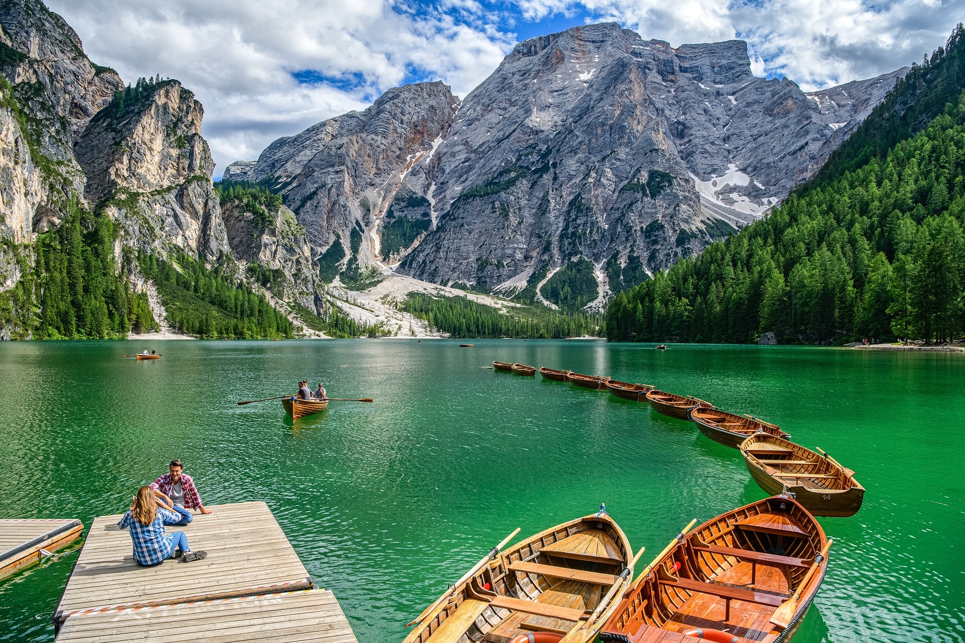 Lake Braies with wooden rowing boats and surrounding mountains, Lago di Braies (Pragser Wildsee), Italy