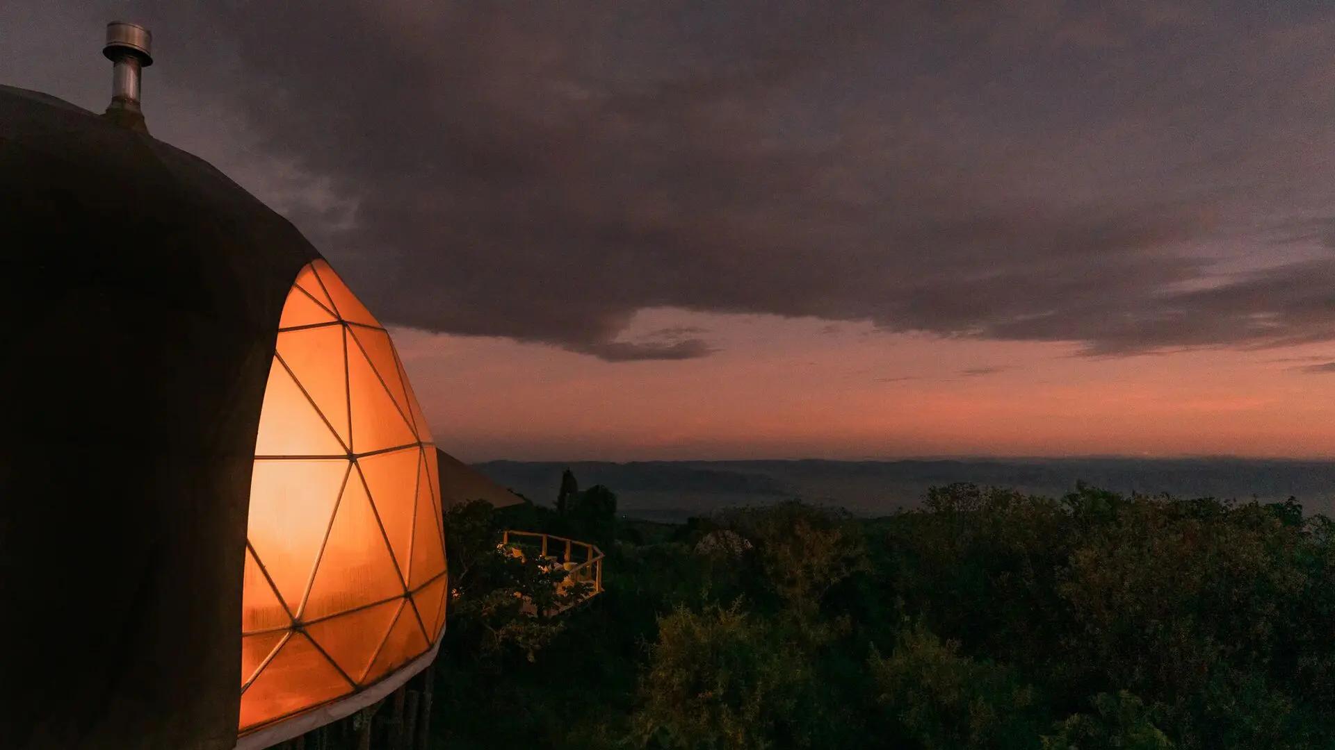 Glowing dome exterior overlooking the highlands at dusk, The Highlands, Asilia, Ngorongoro Conservation Area, Tanzania