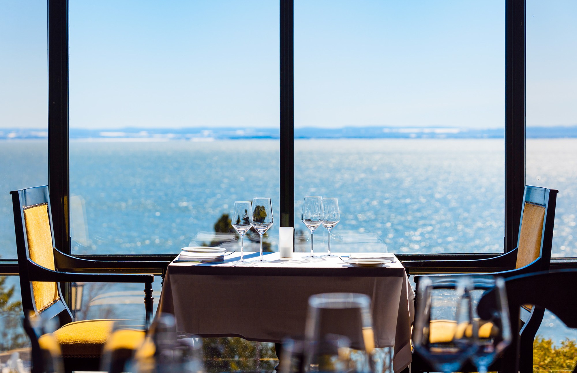 Window-side dining overlooking the St. Lawrence River at Fairmont Le Manoir Richelieu