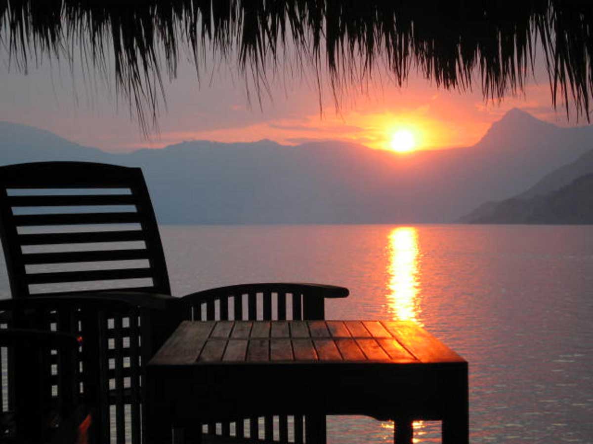Sunset view from a shaded lakeside chair, Laguna Lodge, Lake Atitlán, Guatemala