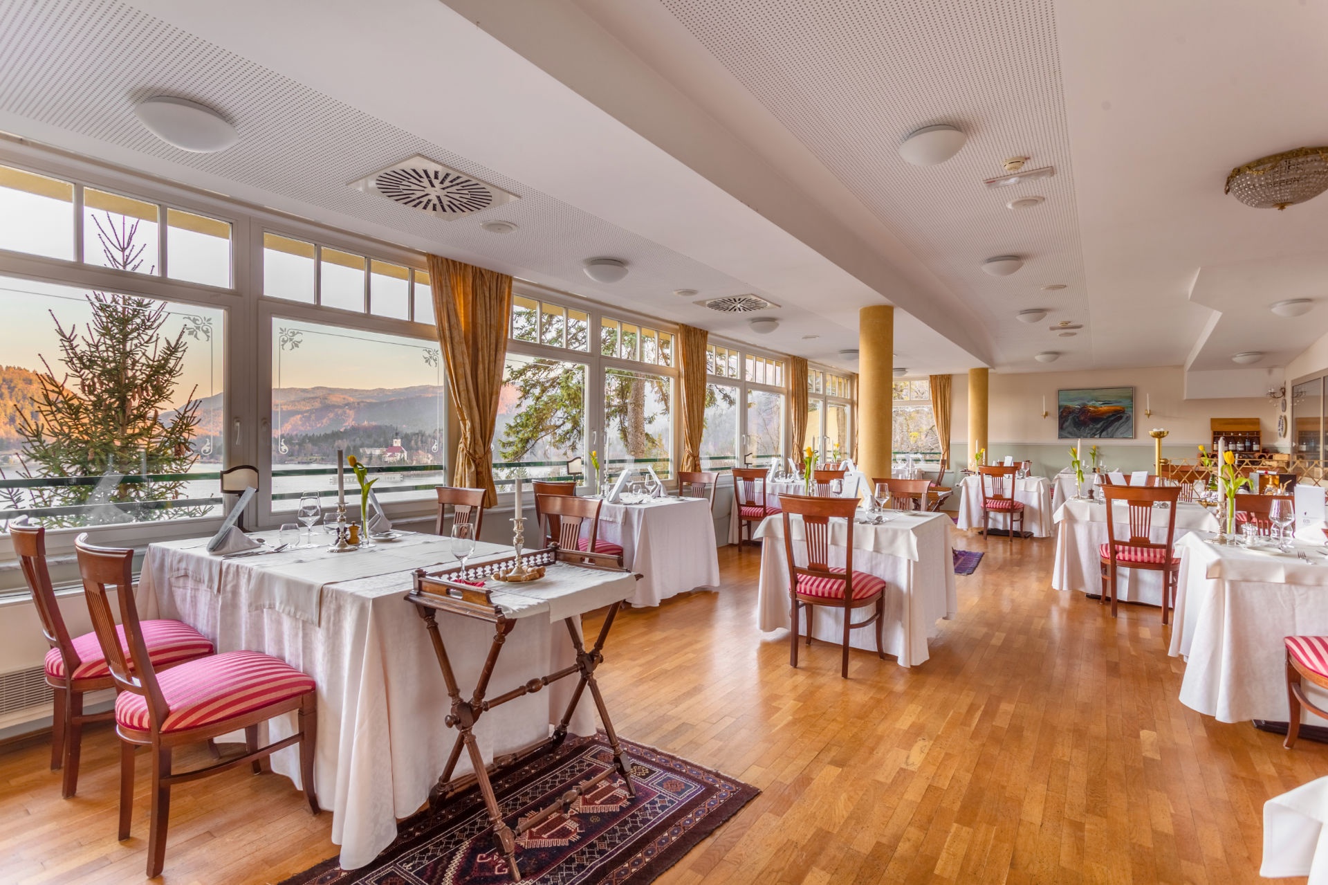 Dining room with views through large windows at Hotel Triglav Bled, Lake Bled, Slovenia