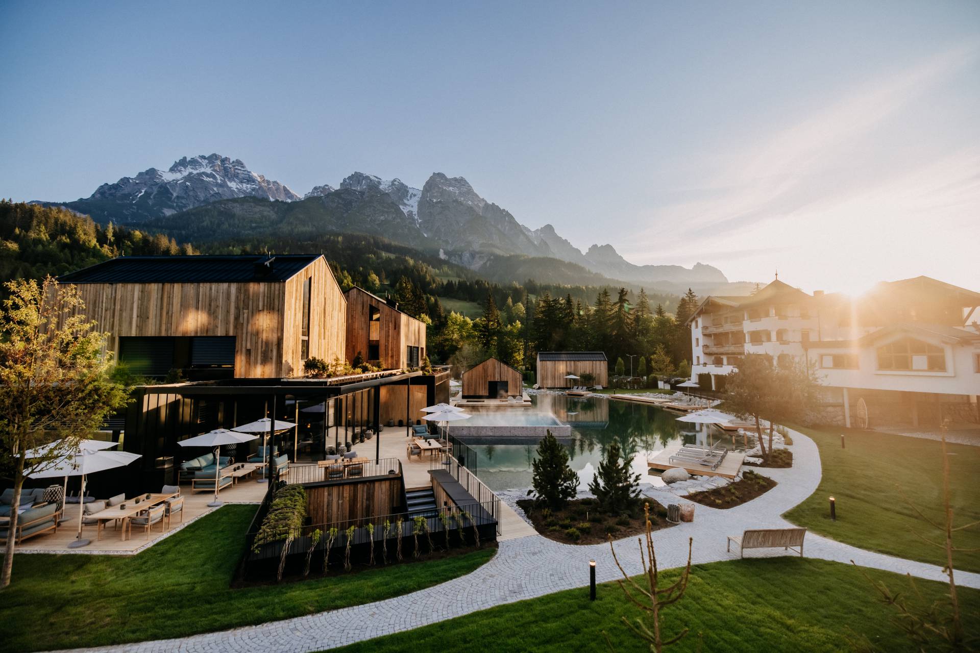 An outdoor pool and alpine landscape at Naturhotel Forsthofgut, Leogang, Austria