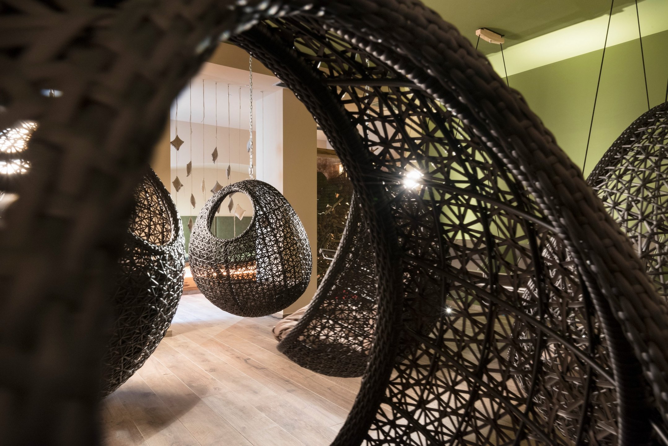 Spa relaxation area with hanging cocoon chairs, Lac Salin Spa & Mountain Resort, Livigno, Italy