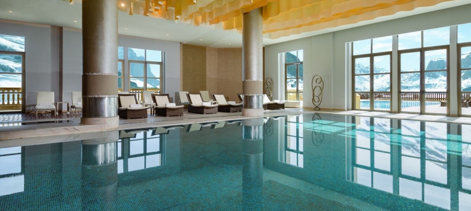 Indoor pool and sun loungers at Pik Palace Shahdag