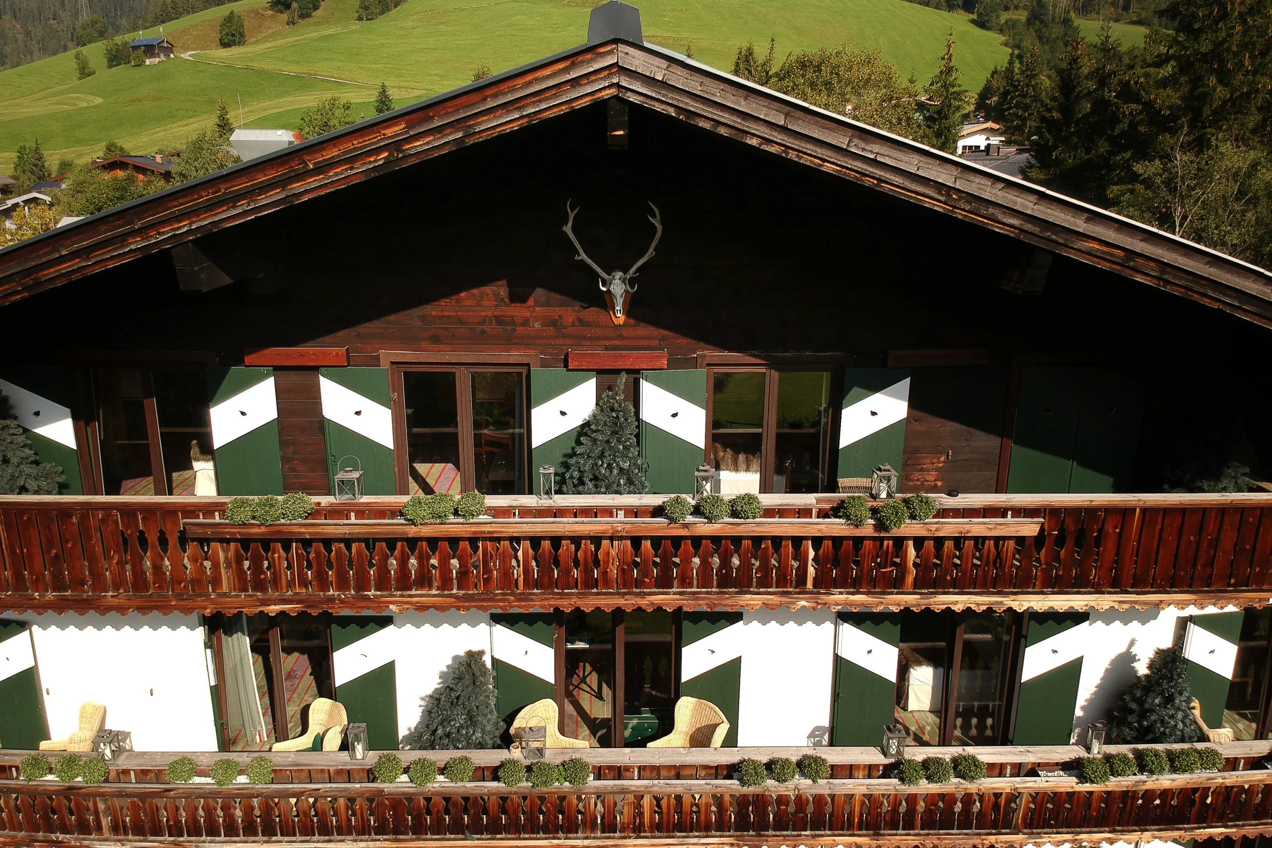 Elevated view of the House of Hütter – Wachtelhof property amid alpine scenery.