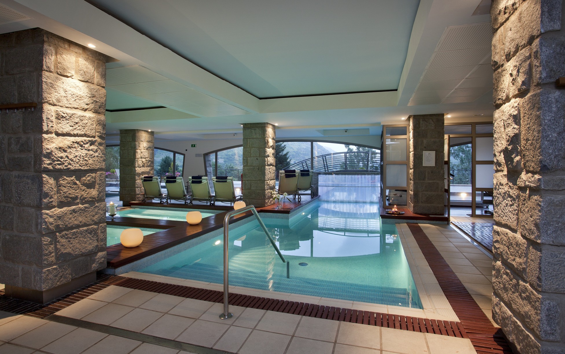 Indoor spa pool with windows overlooking the surrounding landscape at Parador de Vielha, Vielha, Spain