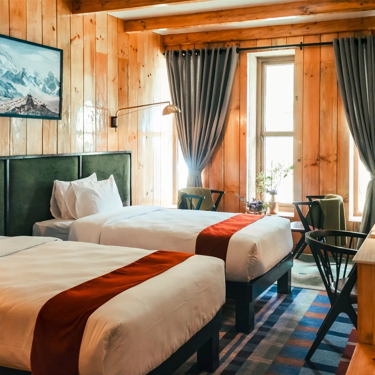 Twin guest room with wooden furnishings and orange bed runners at Yeti Mountain Home, Everest Region (Khumbu), Nepal