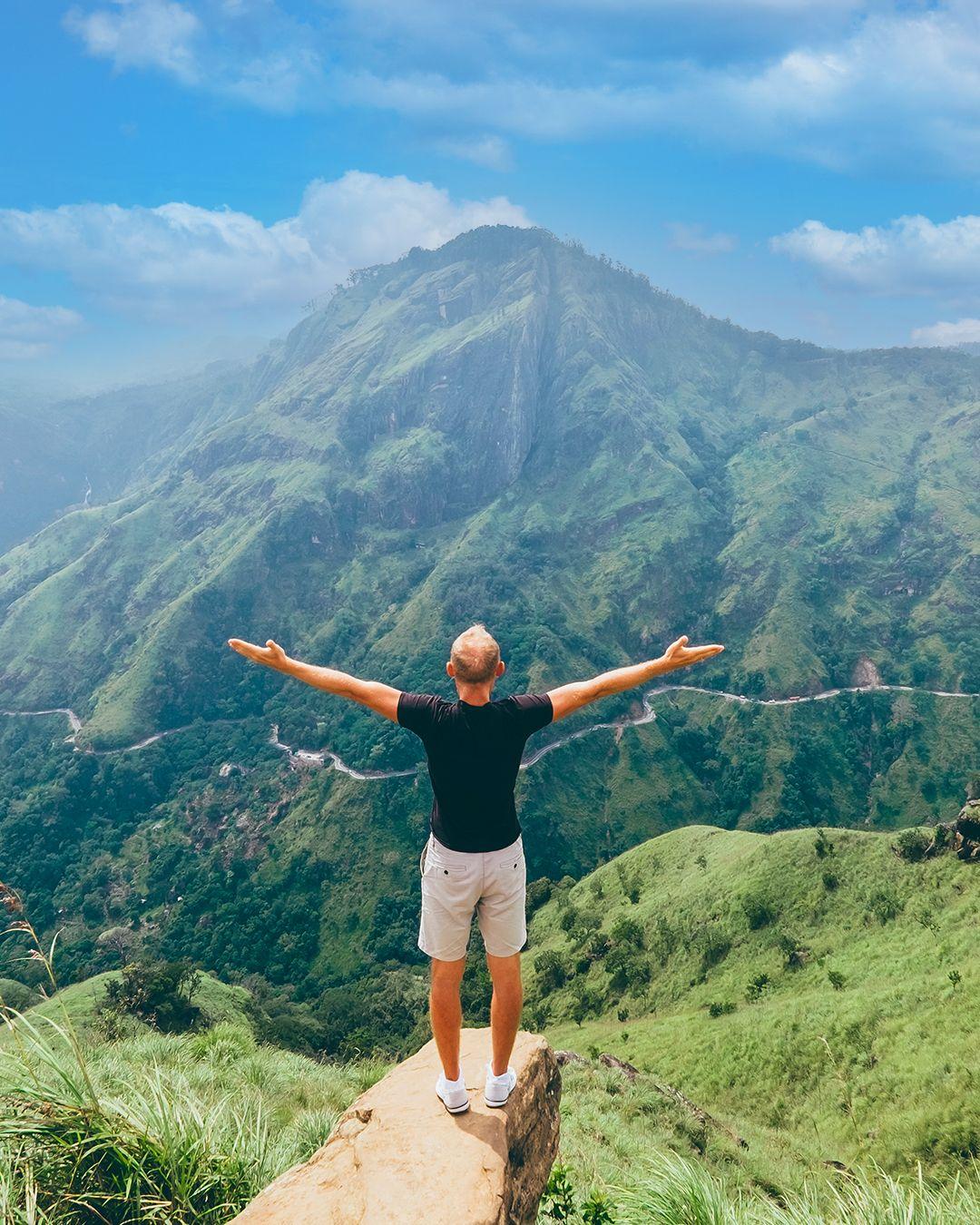 Hiker overlooking a dramatic green mountain valley, 98 Acres Resort, Ella, Sri Lanka