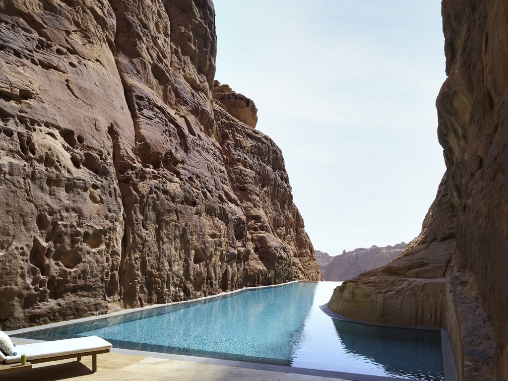 Banyan Tree AlUla rock pool set between towering sandstone walls.