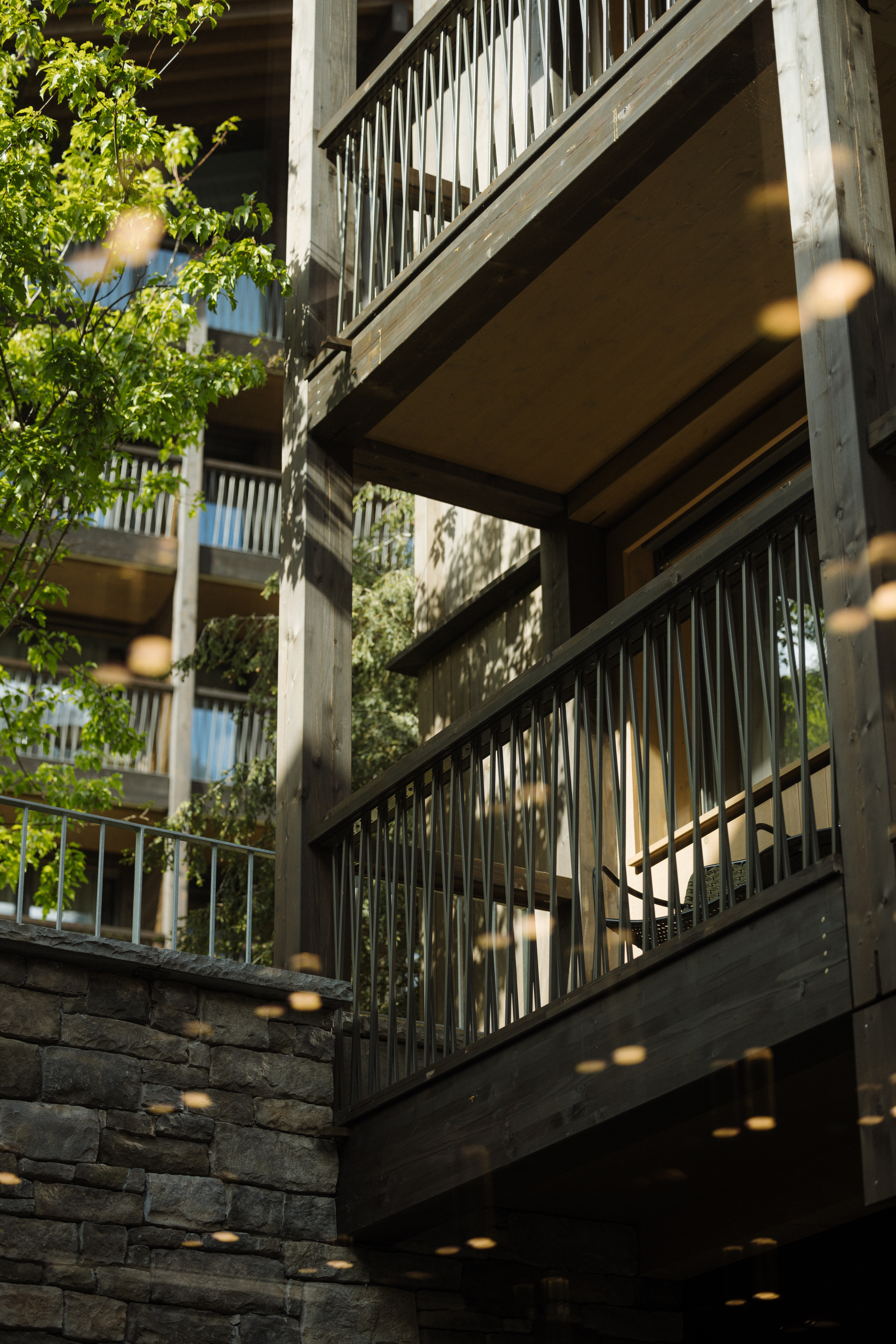 Balconies and stone wall of the building at Bergwelt Grindelwald, Grindelwald, Switzerland