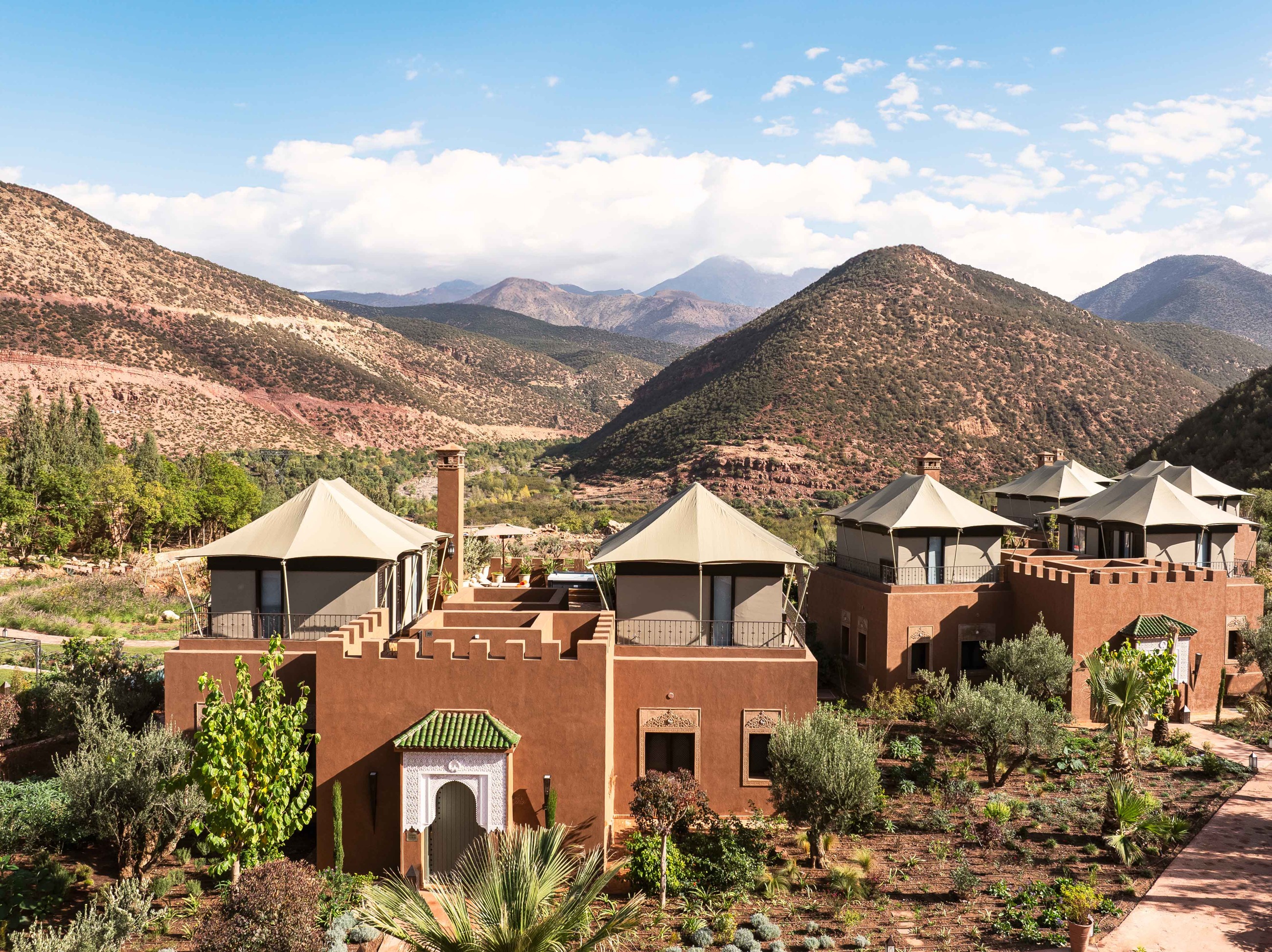Riads with the Atlas Mountains beyond at Kasbah Tamadot, Atlas Mountains, Morocco