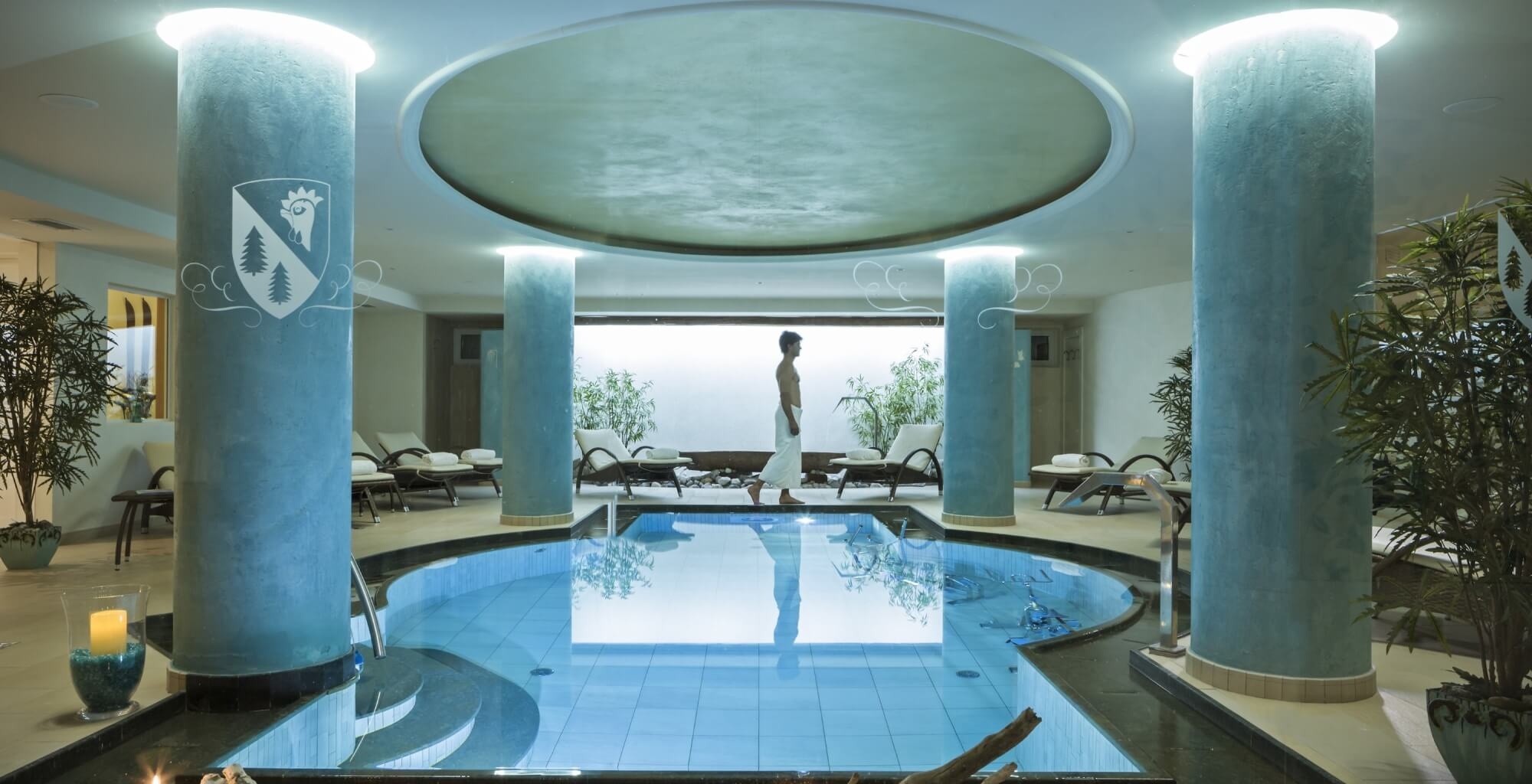 Indoor wellness pool with curved columns at Hotel Chalet del Sogno, Madonna di Campiglio, Italy