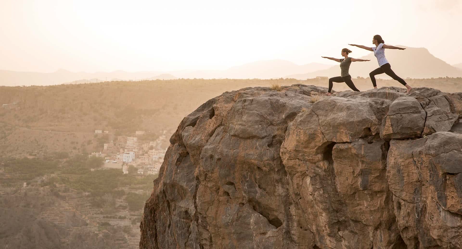 Yoga on a rocky promontory above the canyon, Anantara Al Jabal Al Akhdar, Jebel Akhdar, Oman