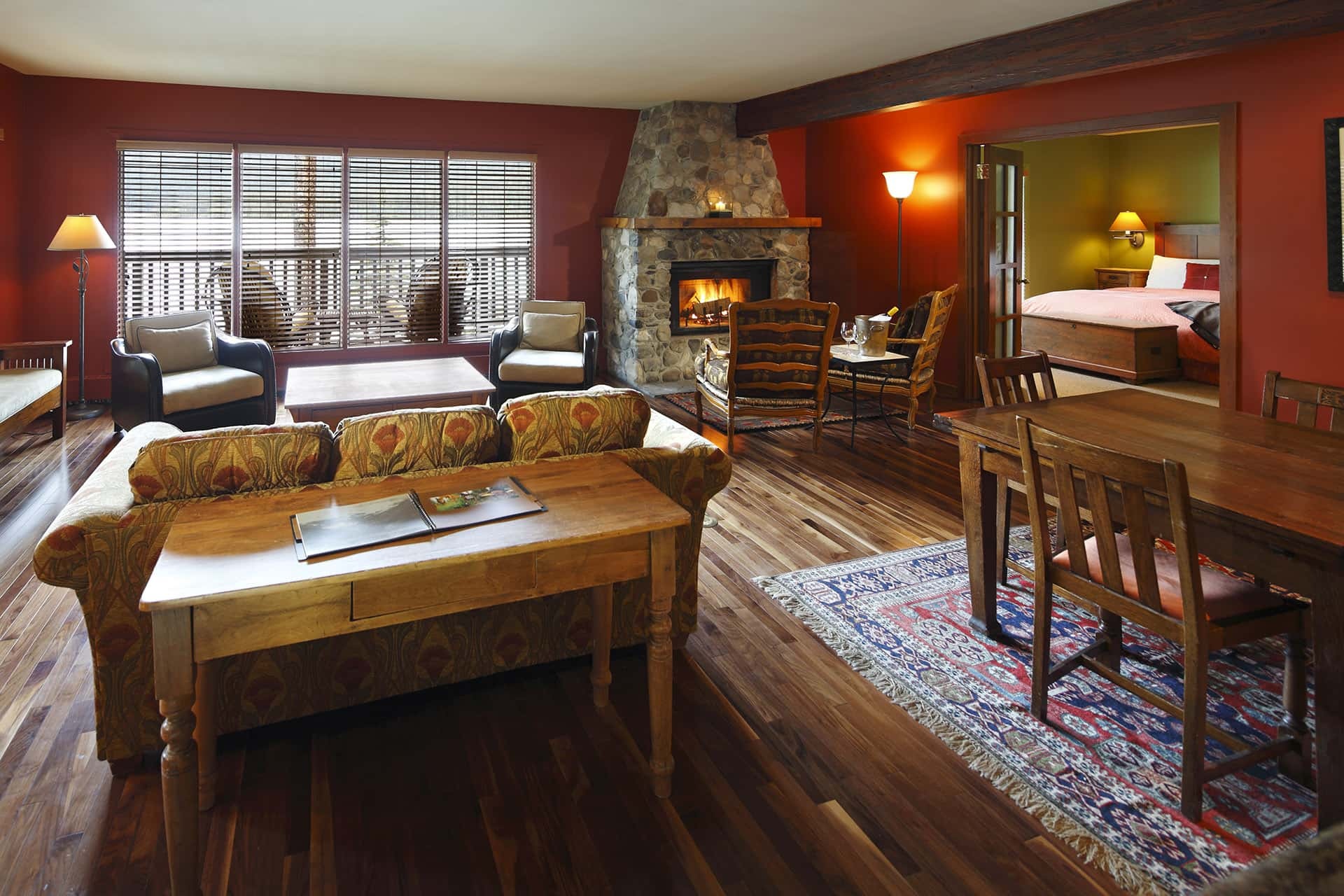 Cabin living area with stone fireplace and adjoining bedroom at Emerald Lake Lodge, Yoho National Park, Canada
