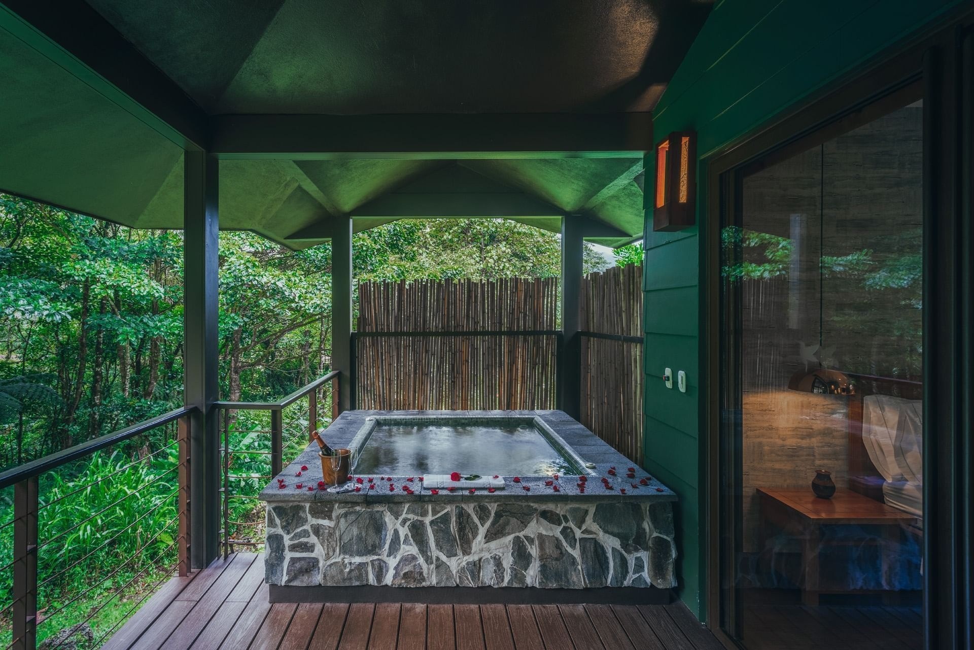 Outdoor whirlpool on a covered wooden deck overlooking the forest, El Silencio Lodge & Spa