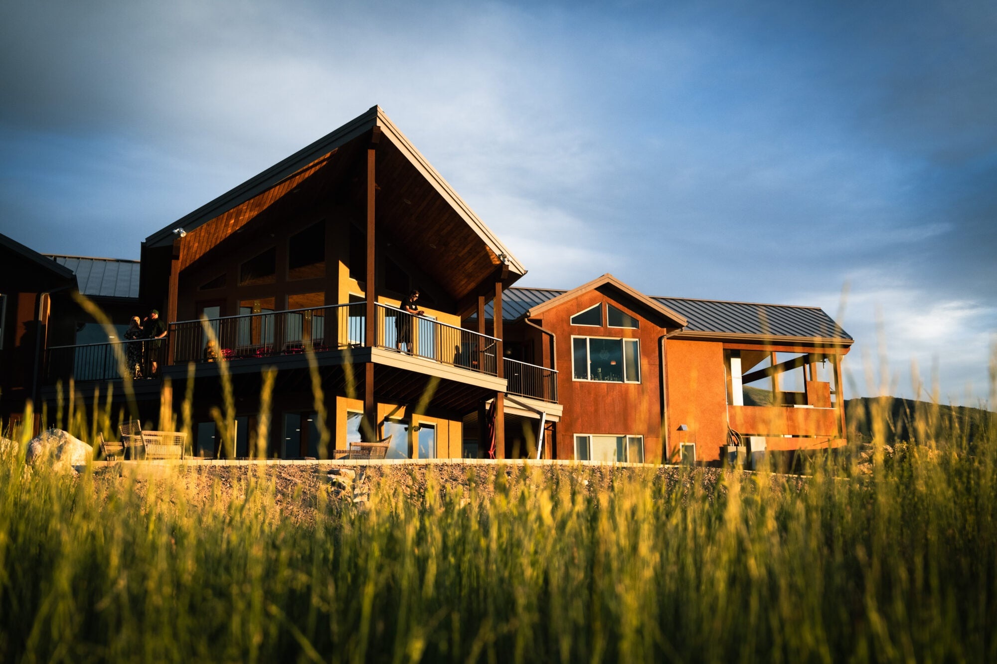 Lodge exterior with wooden decks and meadow grasses at Ruby 360 Lodge, Lamoille, USA