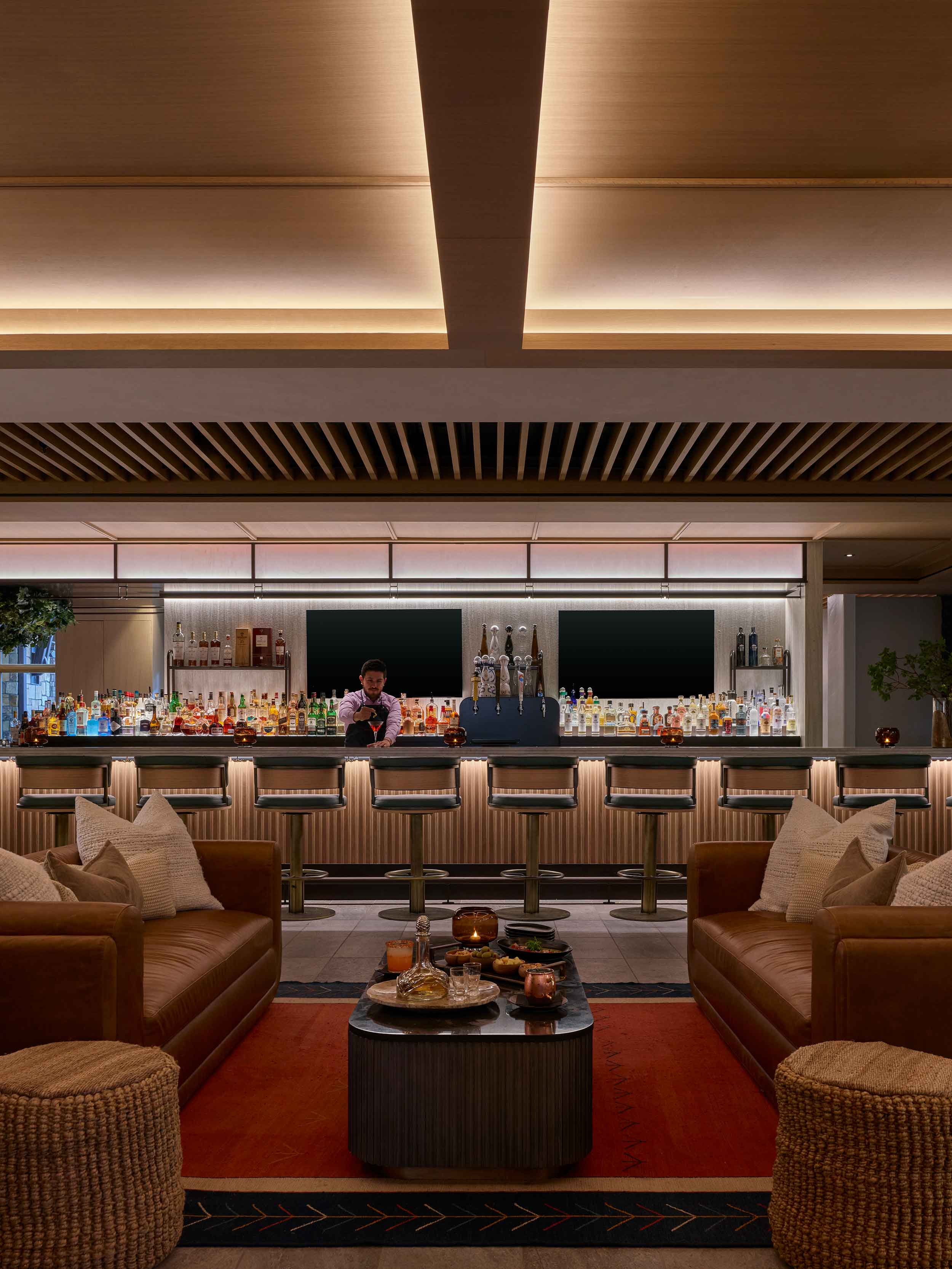 Viceroy Lounge bar and sofas beneath timber ceiling slats at Viceroy Snowmass.