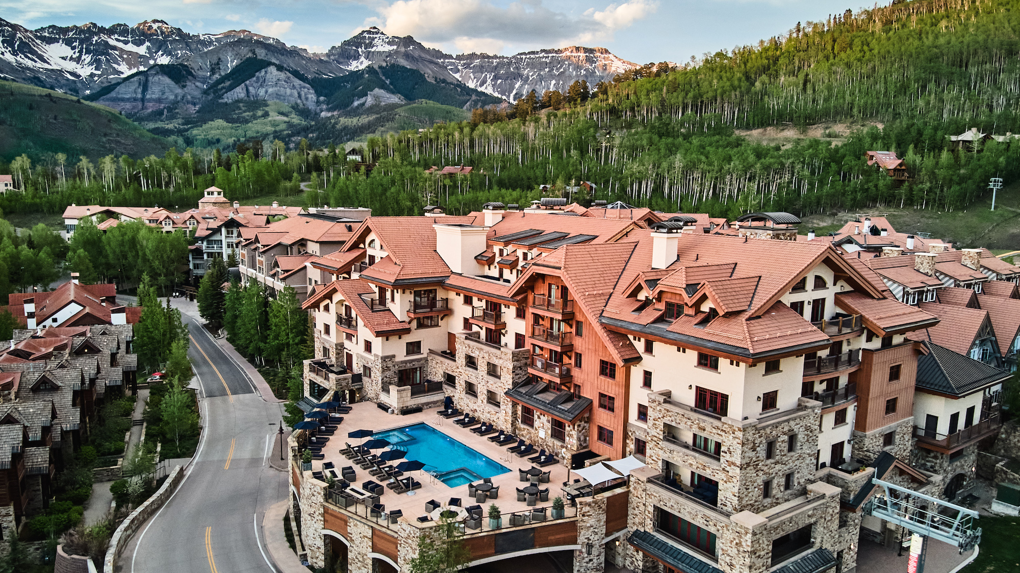 Madeline Hotel & Residences and its outdoor pool beneath the San Juan Mountains, Telluride, USA