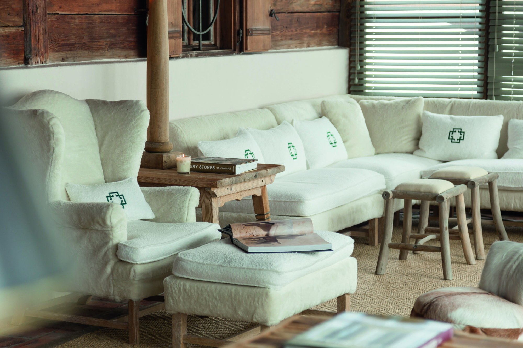 White cushioned lounge seating in a timber interior at House of Hütter – Wachtelhof, Hinterthal, Austria