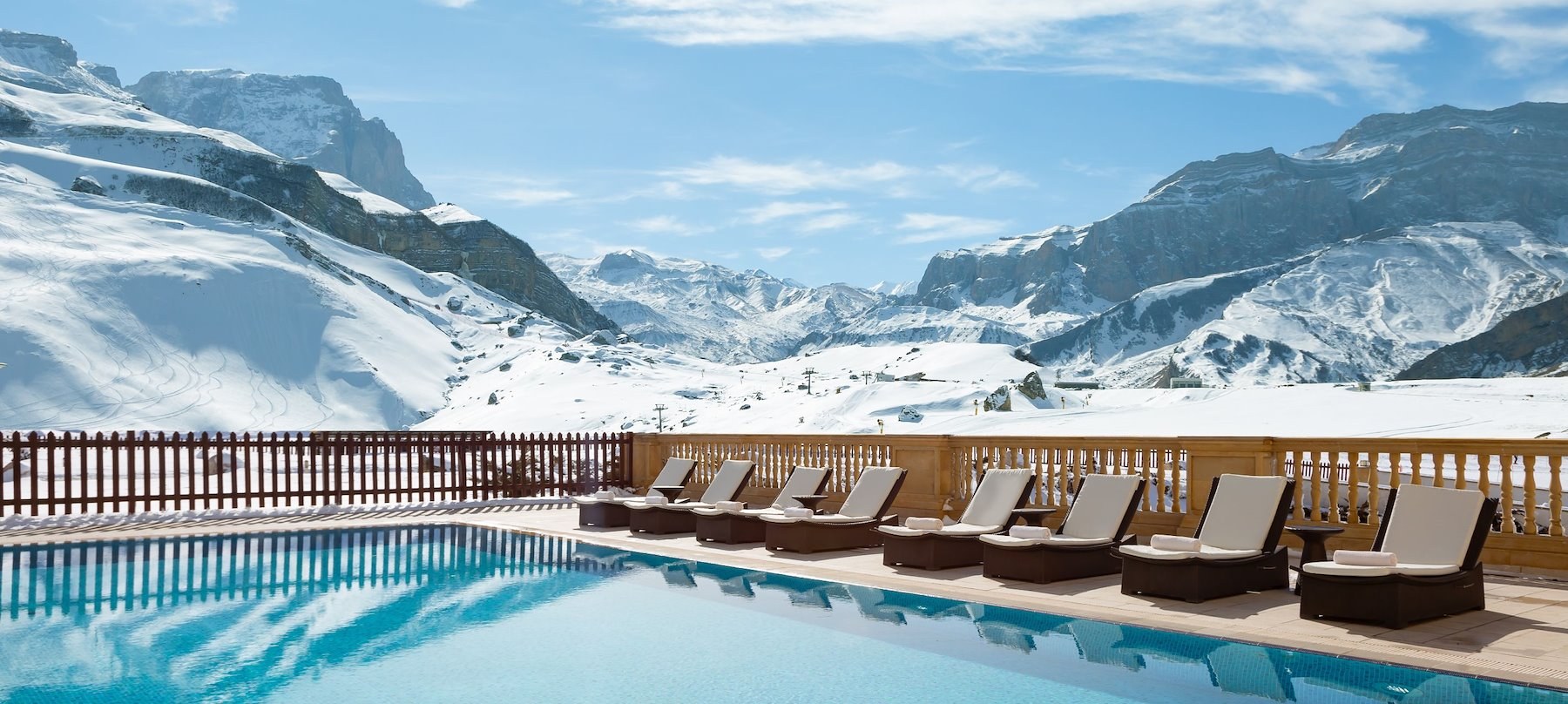 Outdoor swimming pool facing snowy Caucasus peaks at Pik Palace Shahdag