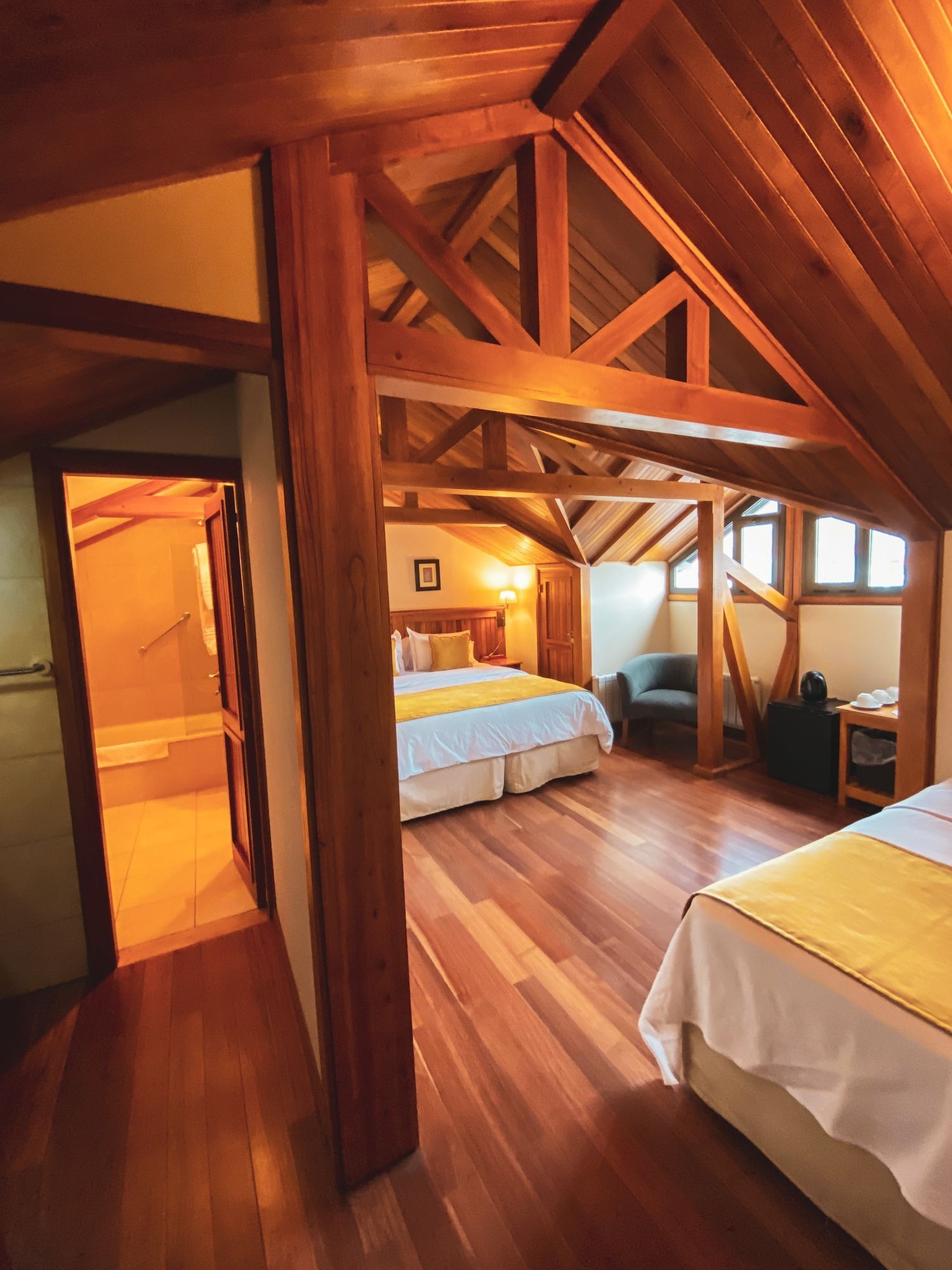 Wood-panelled guest room with exposed beams at Hostería Senderos, El Chaltén, Argentina