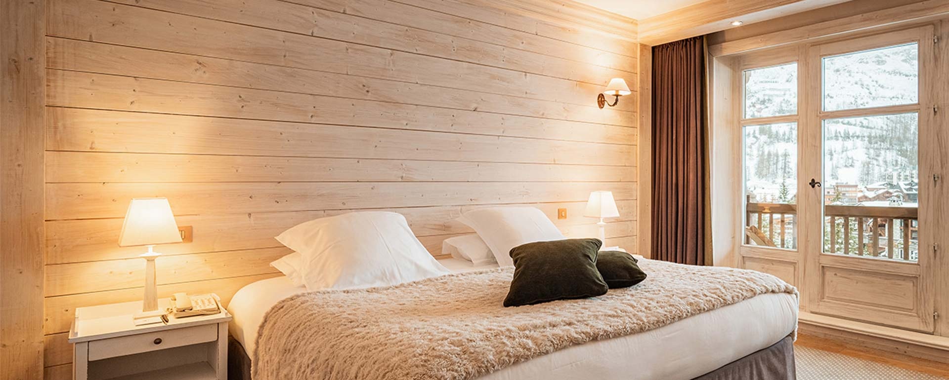 Luxe room with wood panelling at Les Barmes de l'Ours, Val d'Isère, France
