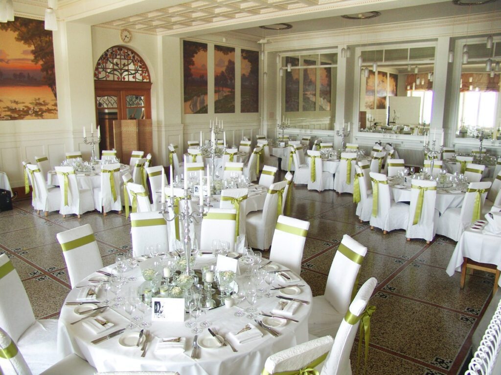 Belle Epoque dining room set with white tablecloths and pale green chair sashes at Berghotel Schatzalp, Davos, Switzerland