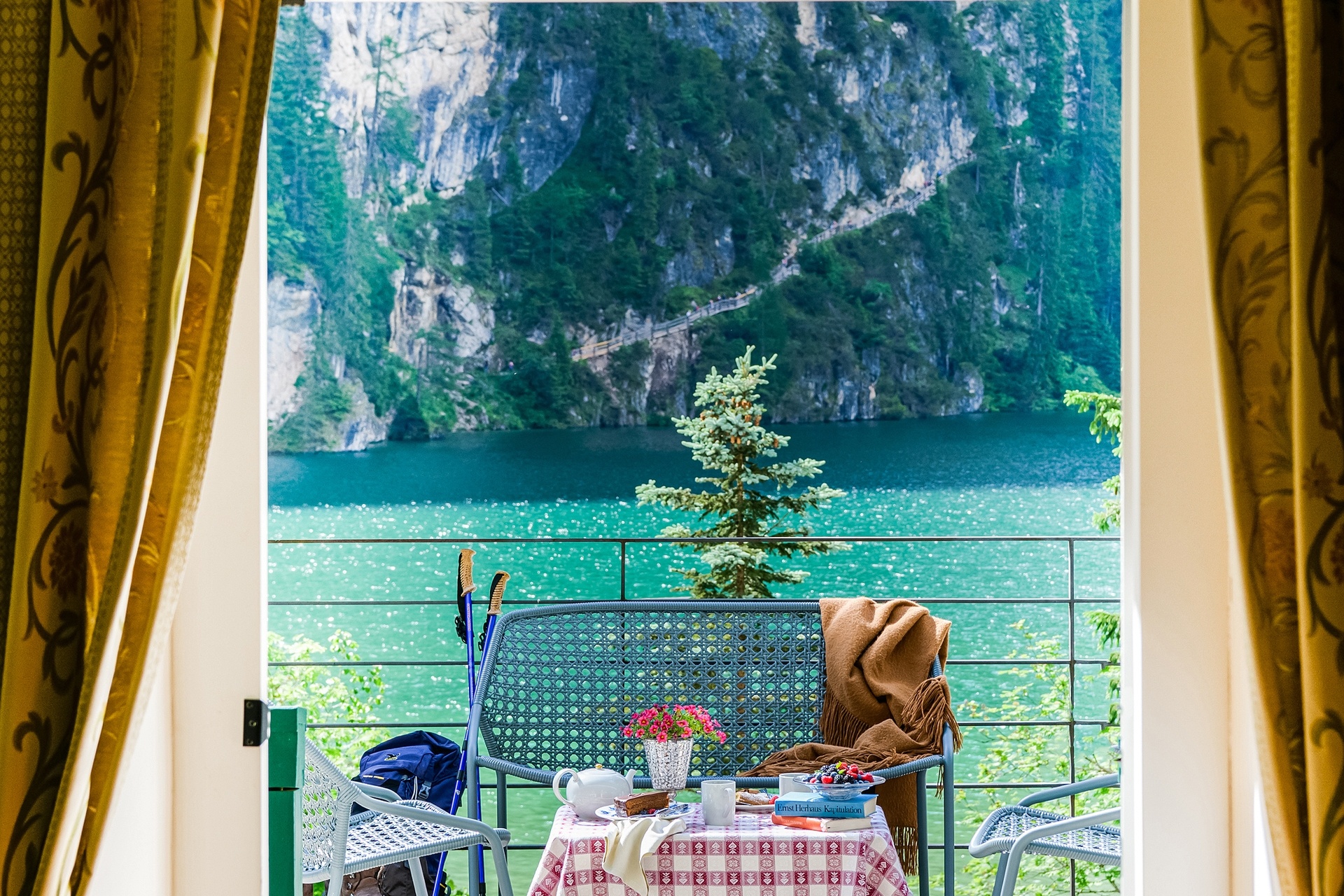 Lake and mountain views through an open balcony doorway at Hotel Lago di Braies, Lago di Braies (Pragser Wildsee), Italy