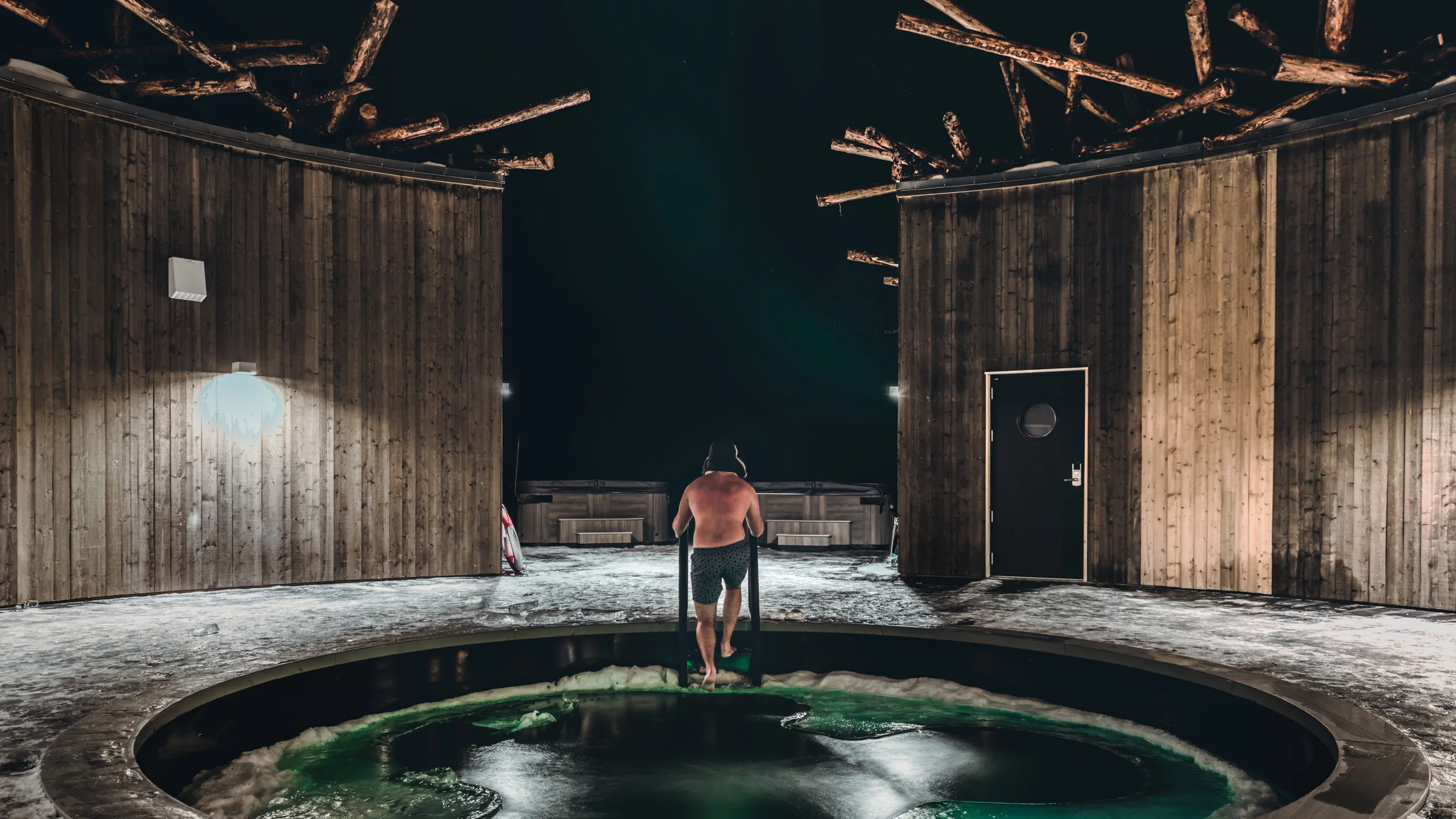 Guest using the illuminated cold plunge at Arctic Bath, Harads, Swedish Lapland