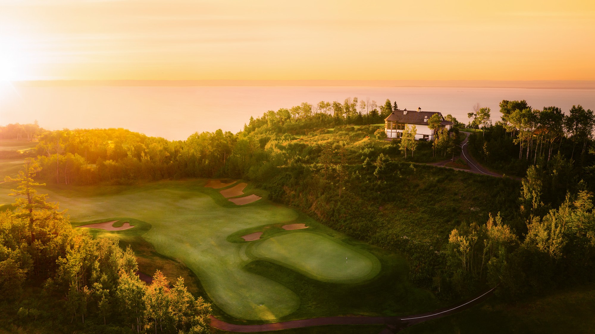 Golf fairways and the hotel at sunset at Fairmont Le Manoir Richelieu