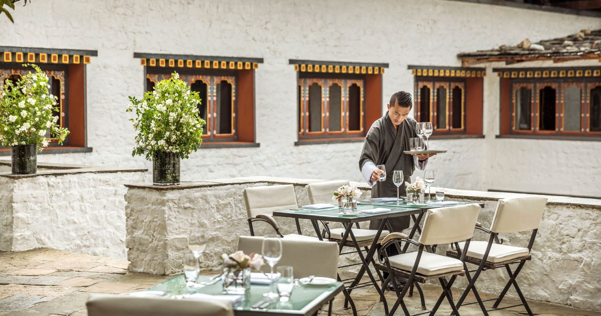 Outdoor courtyard seating beside the hotel building at COMO Uma Paro, Paro, Bhutan