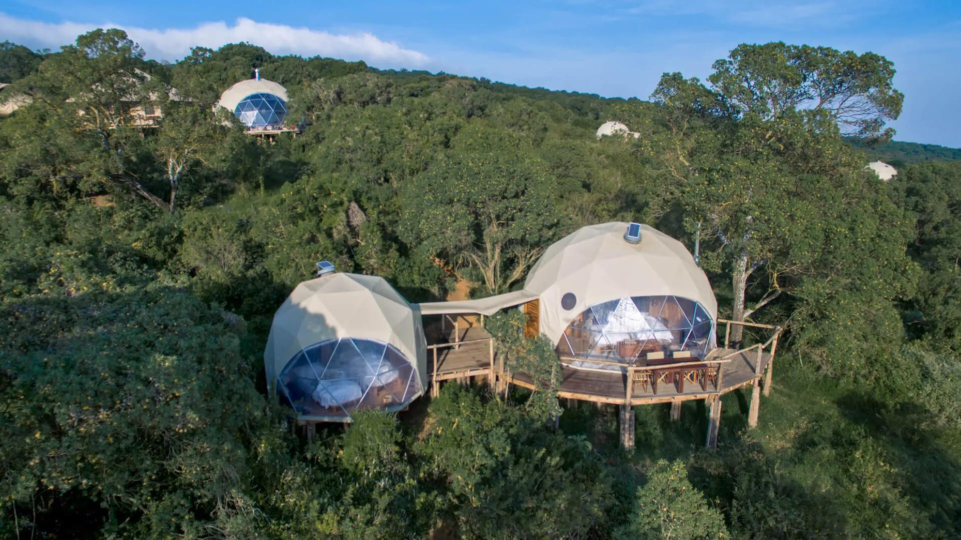 Aerial view of geodesic dome exteriors nestled in green highland forest, The Highlands, Asilia, Ngorongoro Conservation Area, Tanzania