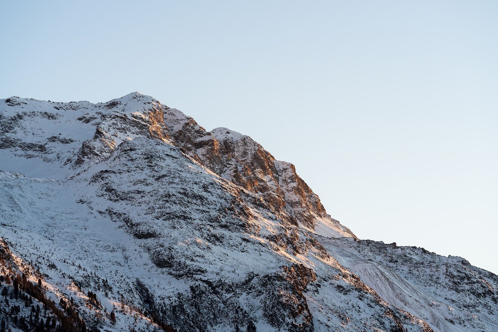 Snow-covered mountain ridge in warm evening light, Carlton Hotel St. Moritz, St. Moritz, Switzerland