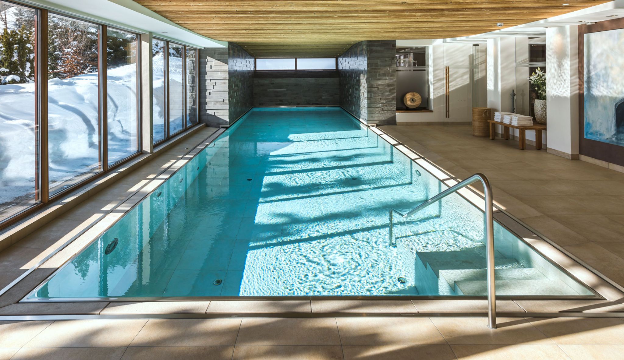 Indoor swimming pool beside snowy garden windows, Hotel Tannenhof, St. Anton am Arlberg, Austria
