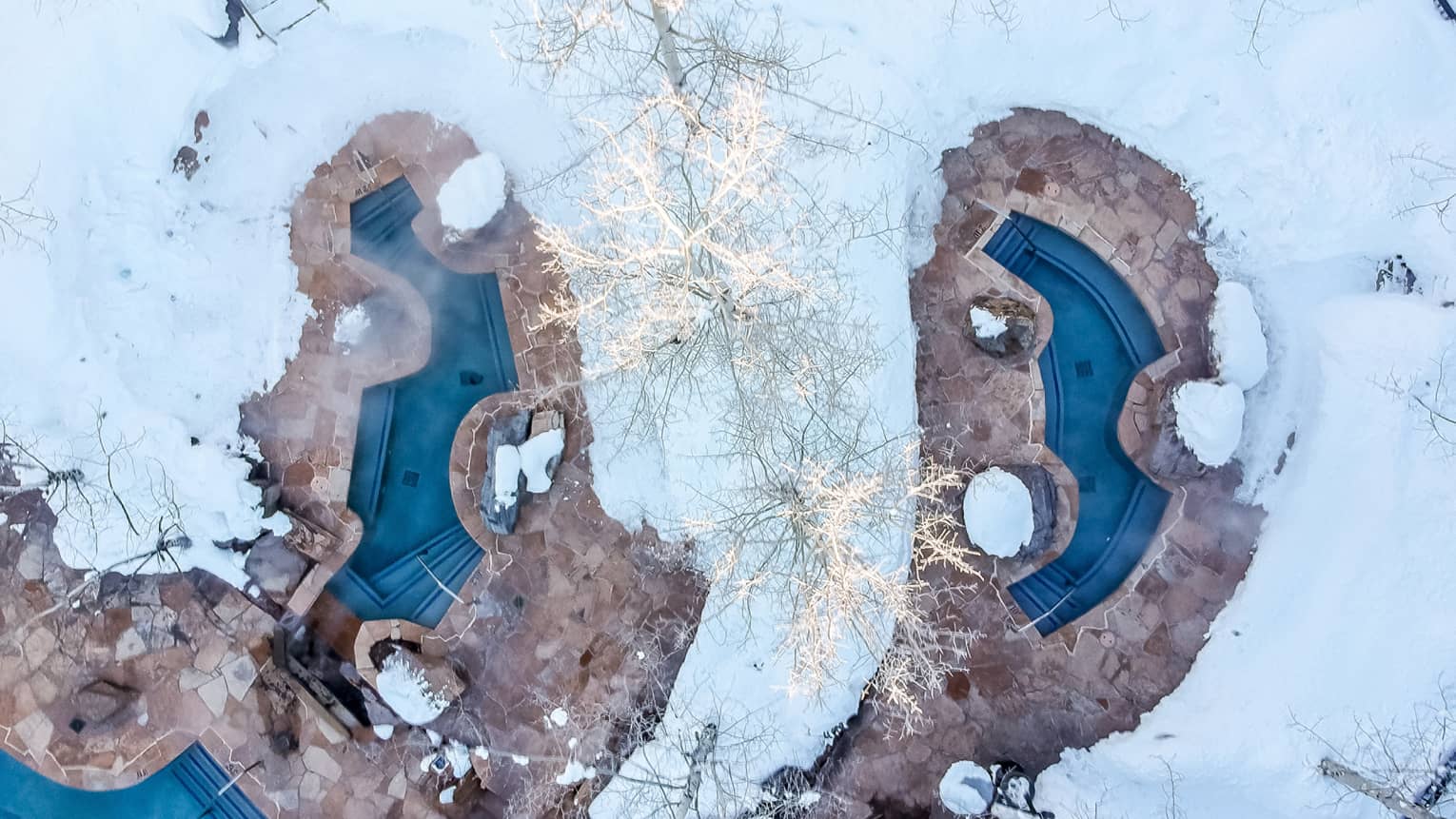Snow-covered outdoor pool area, Four Seasons Resort Jackson Hole, Teton Village, USA