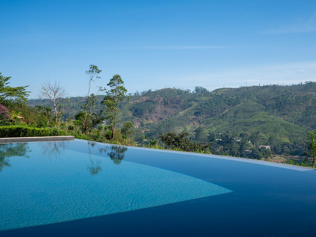 Infinity swimming pool overlooking the green hills at Camellia Hills, Sri Lanka