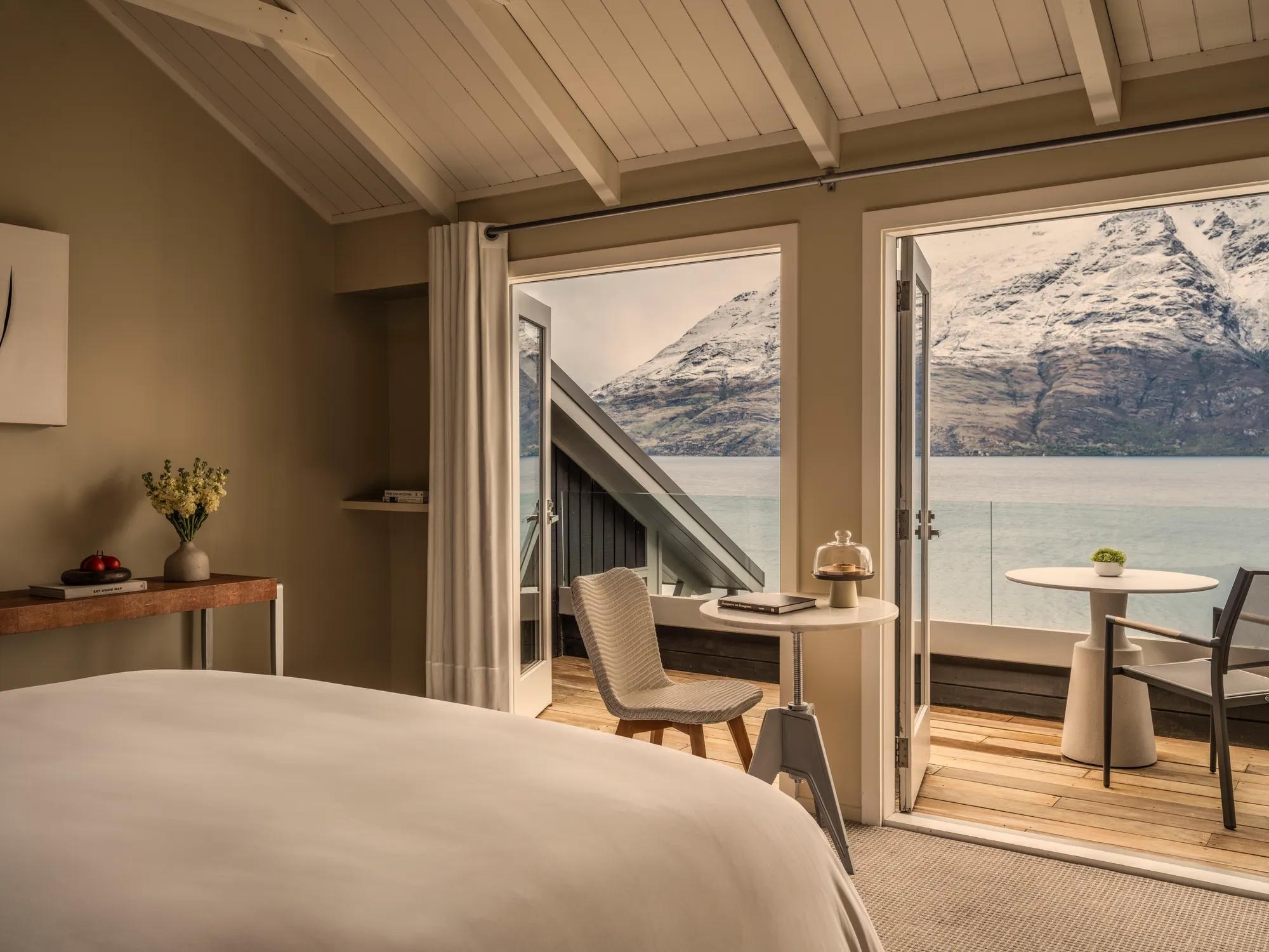 Guest bedroom opening onto a lake-view terrace at Matakauri Lodge, Queenstown, New Zealand