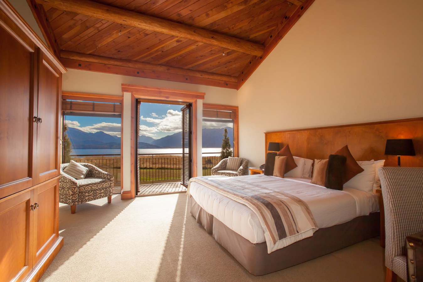 Timber-lined guest room overlooking Lake Te Anau at Fiordland Lodge