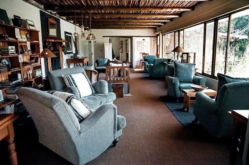 Comfortable lounge with armchairs and broad windows, Cleopatra Mountain Farmhouse, Drakensberg, KwaZulu-Natal, South Africa