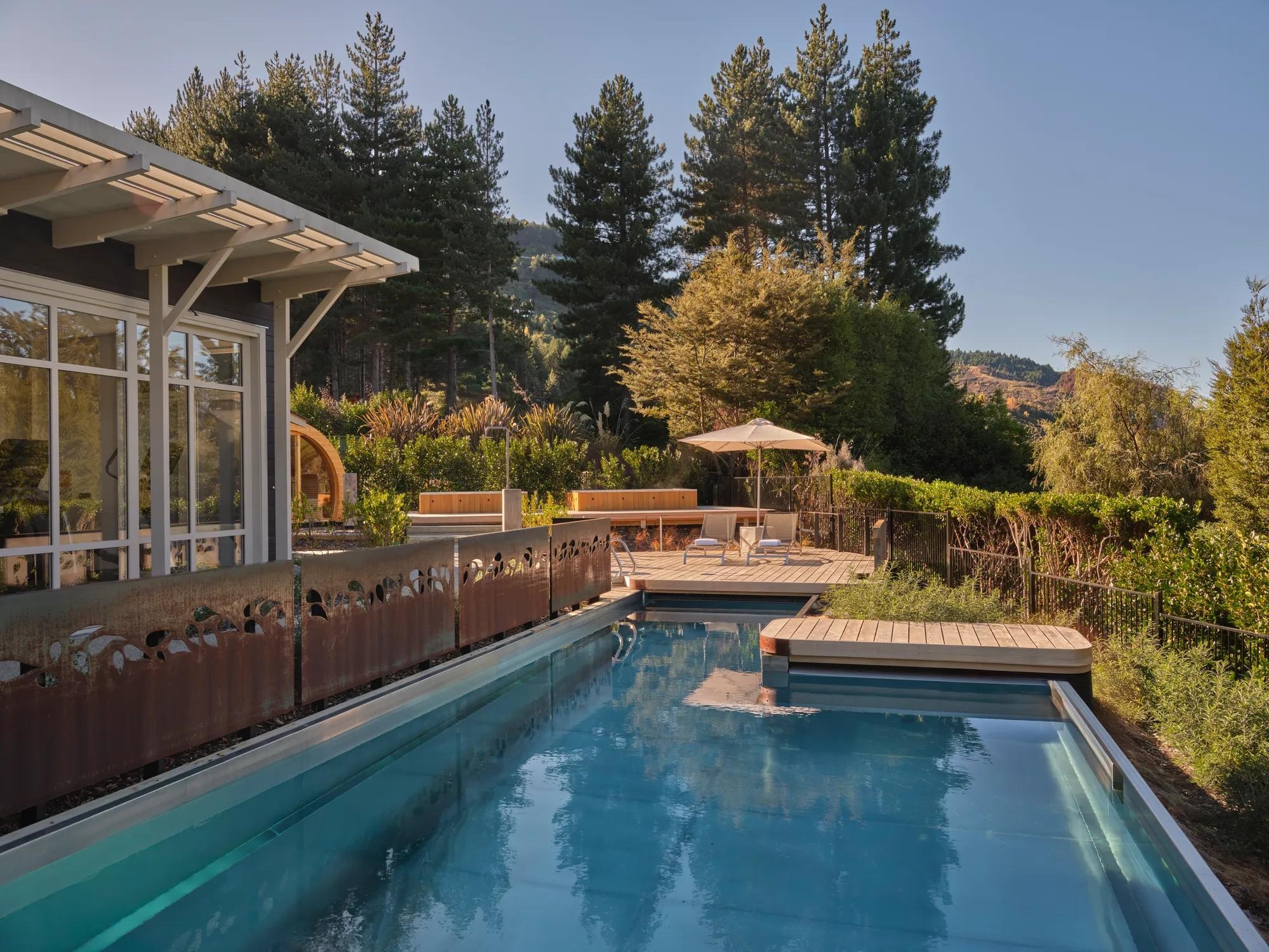 Outdoor swimming pool and sun loungers at Matakauri Lodge, Queenstown, New Zealand