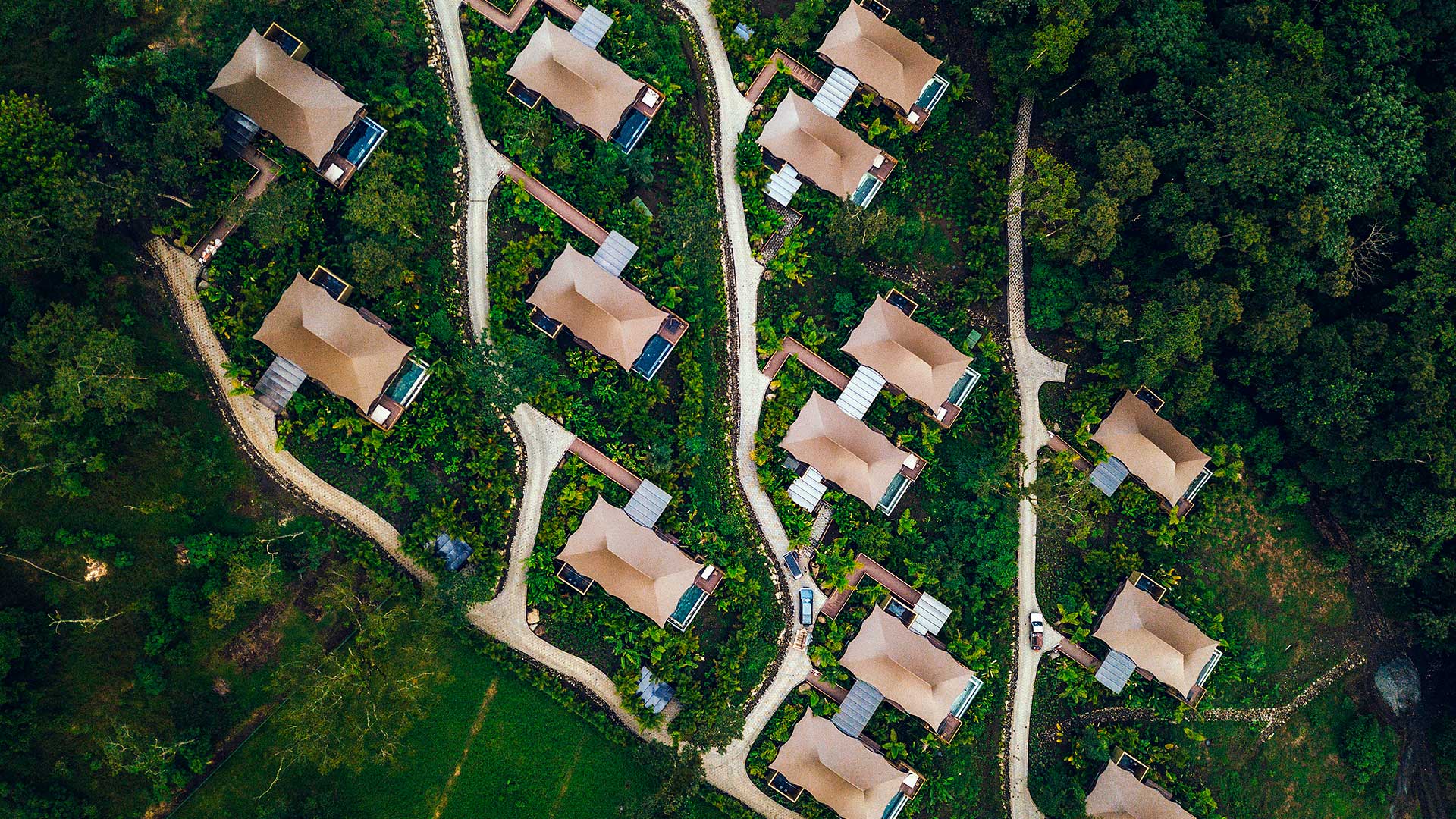 Overhead view of tented villas and winding rainforest paths, Nayara Tented Camp, Arenal, Costa Rica