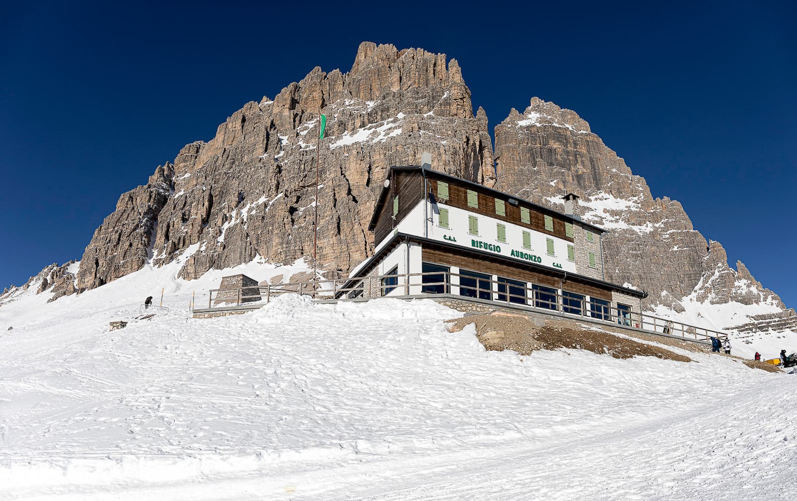 Snow-covered slopes around Rifugio Auronzo beneath the Dolomite cliffs, Tre Cime di Lavaredo, Italy