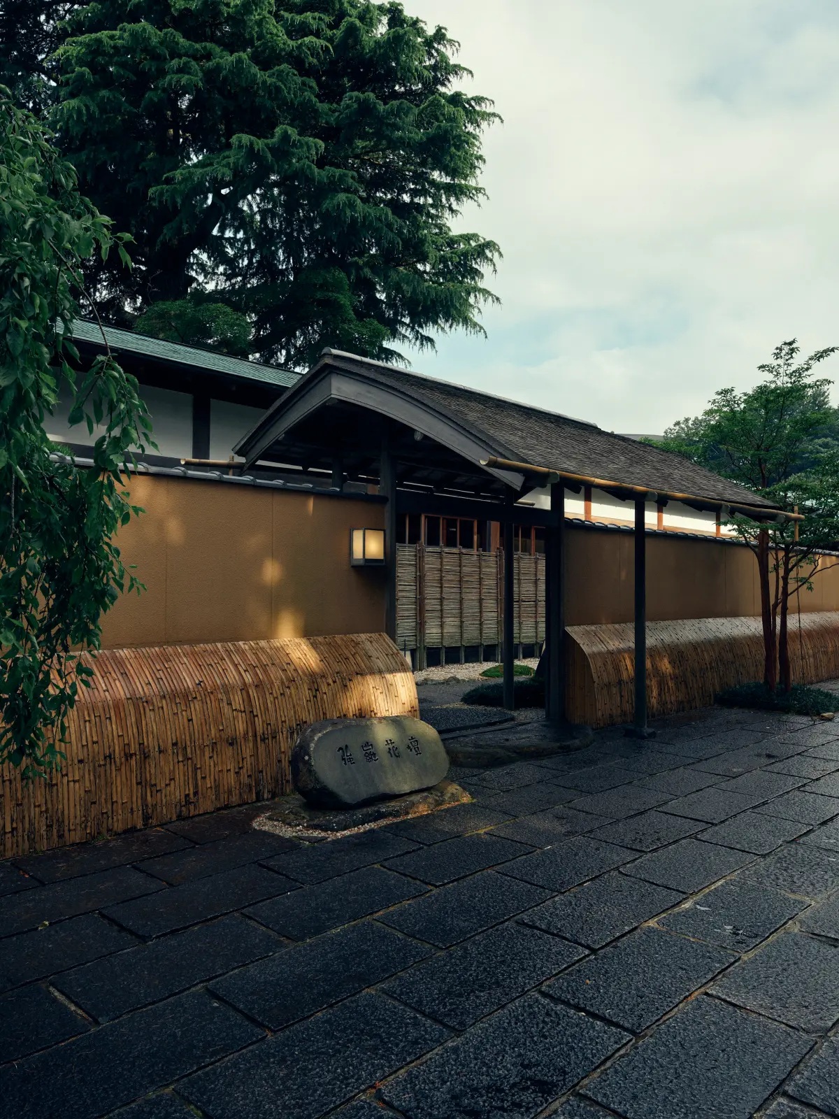 Traditional entrance surrounded by greenery at Gora Kadan, Hakone, Japan
