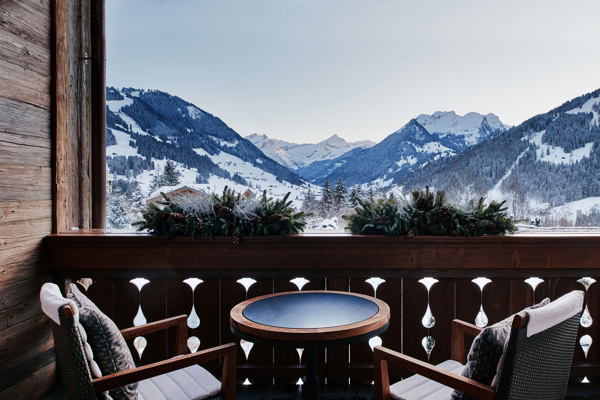 Balcony with chairs and alpine mountain view at The Alpina Gstaad, Gstaad, Switzerland