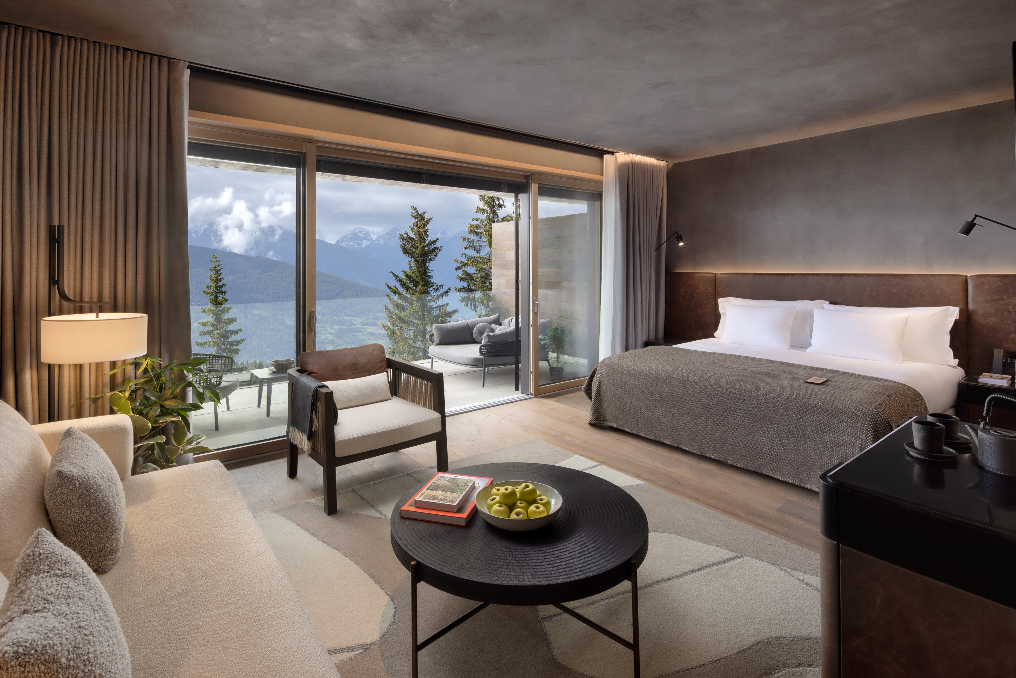 Guest room with full-height bay windows opening onto an Alpine-view terrace, Six Senses Crans-Montana, Crans-Montana, Switzerland