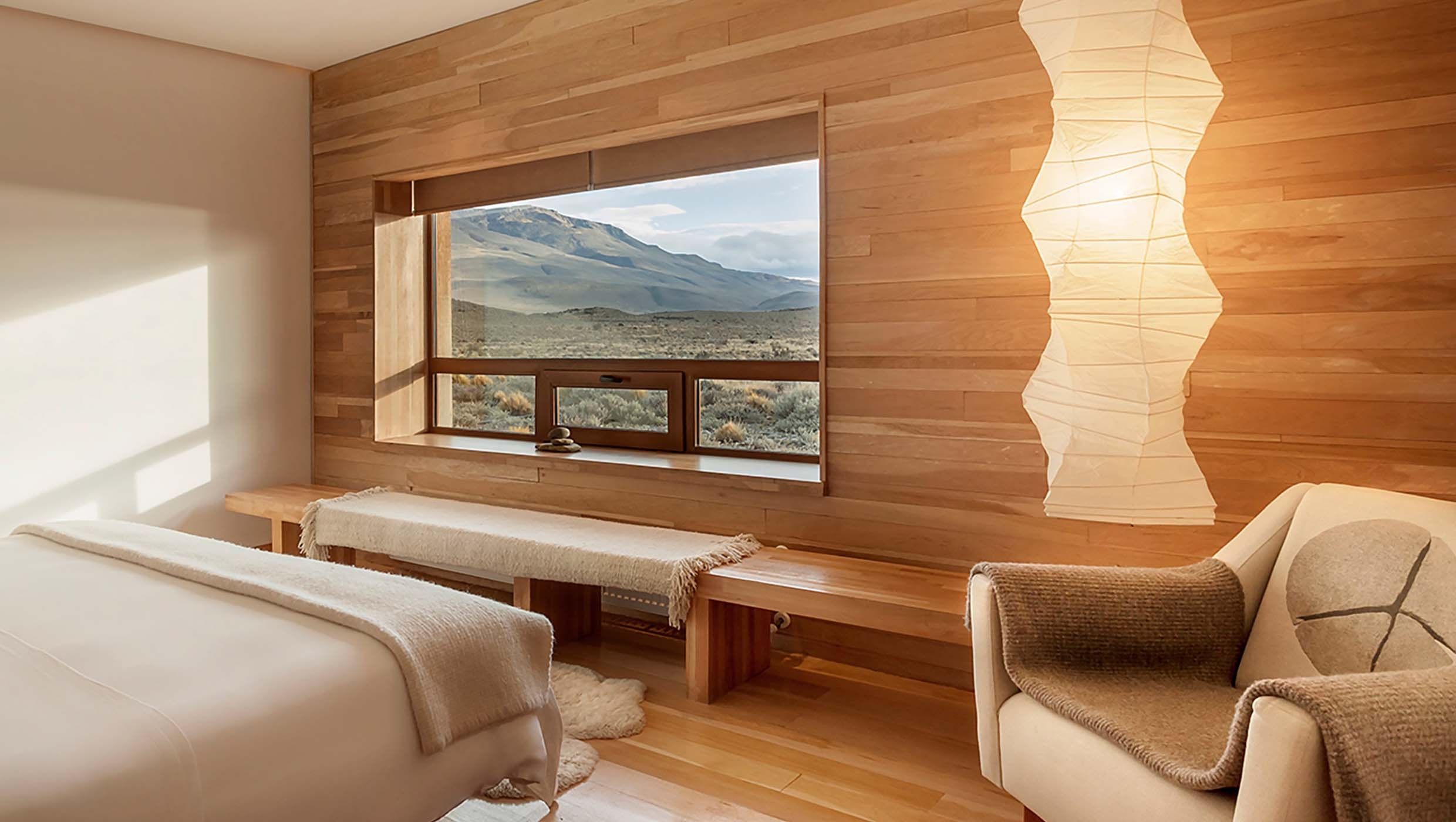 Wood-panelled guest room overlooking the landscape at Tierra Patagonia, Torres del Paine, Chile