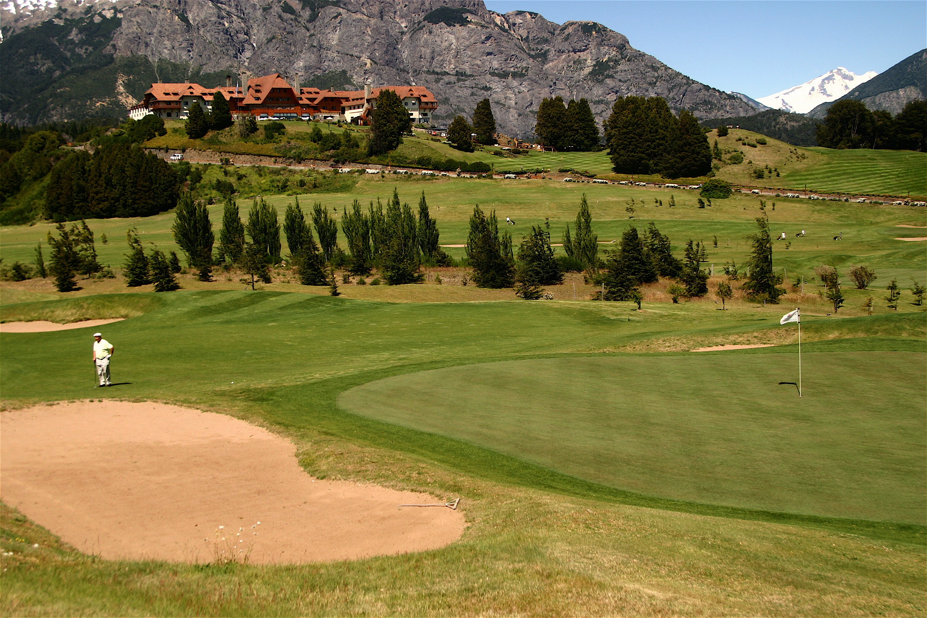 Golf green with the hotel and mountains beyond at Llao Llao Hotel & Resort, Bariloche, Argentina