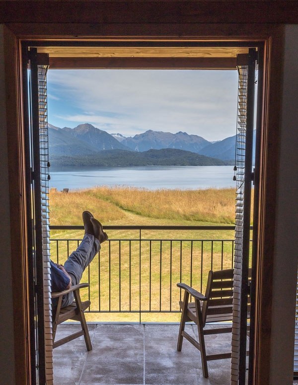 View through a timber-framed doorway towards Lake Te Anau at Fiordland Lodge