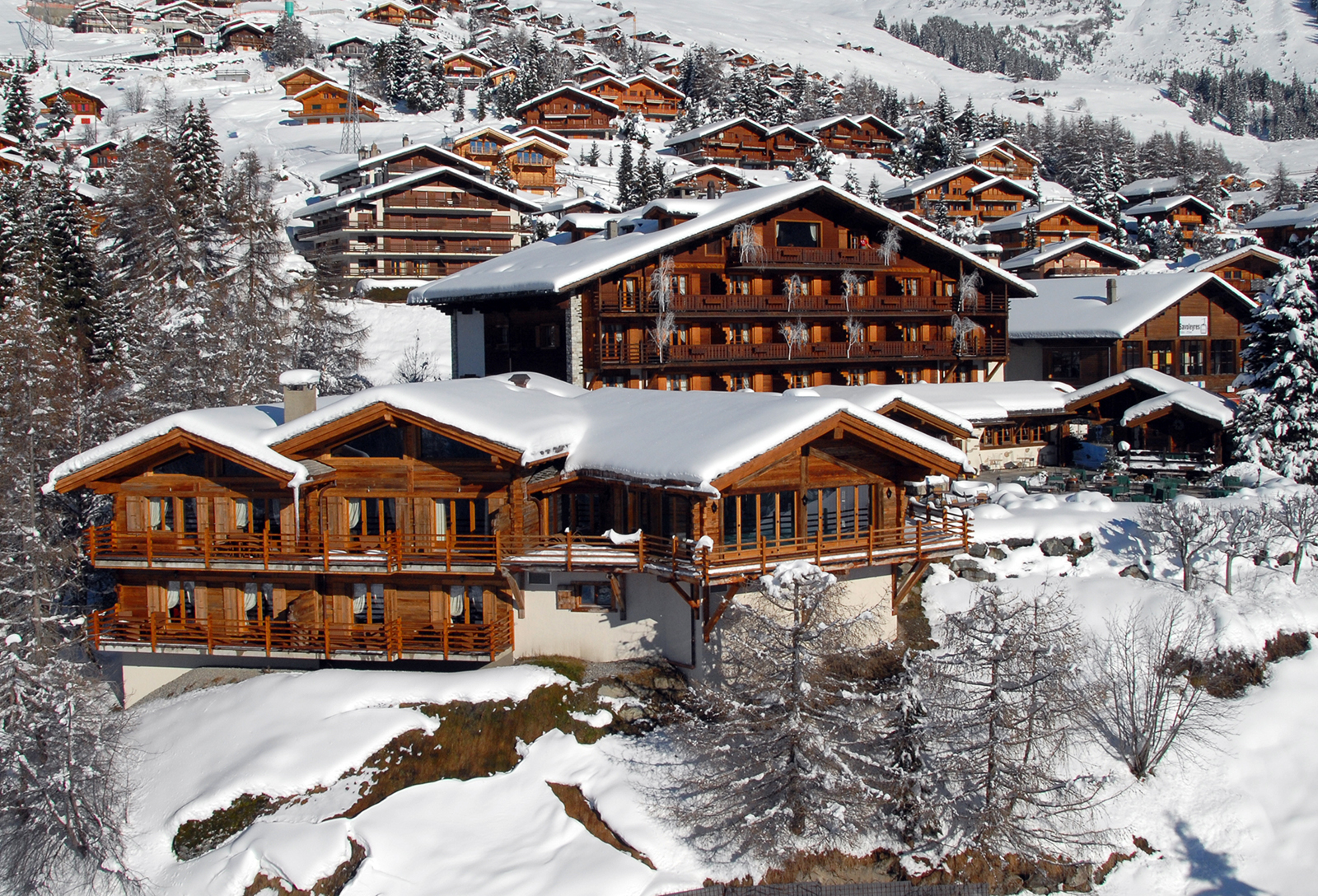 Snow-covered hotel exterior in its mountain setting, Chalet d'Adrien, Verbier, Switzerland